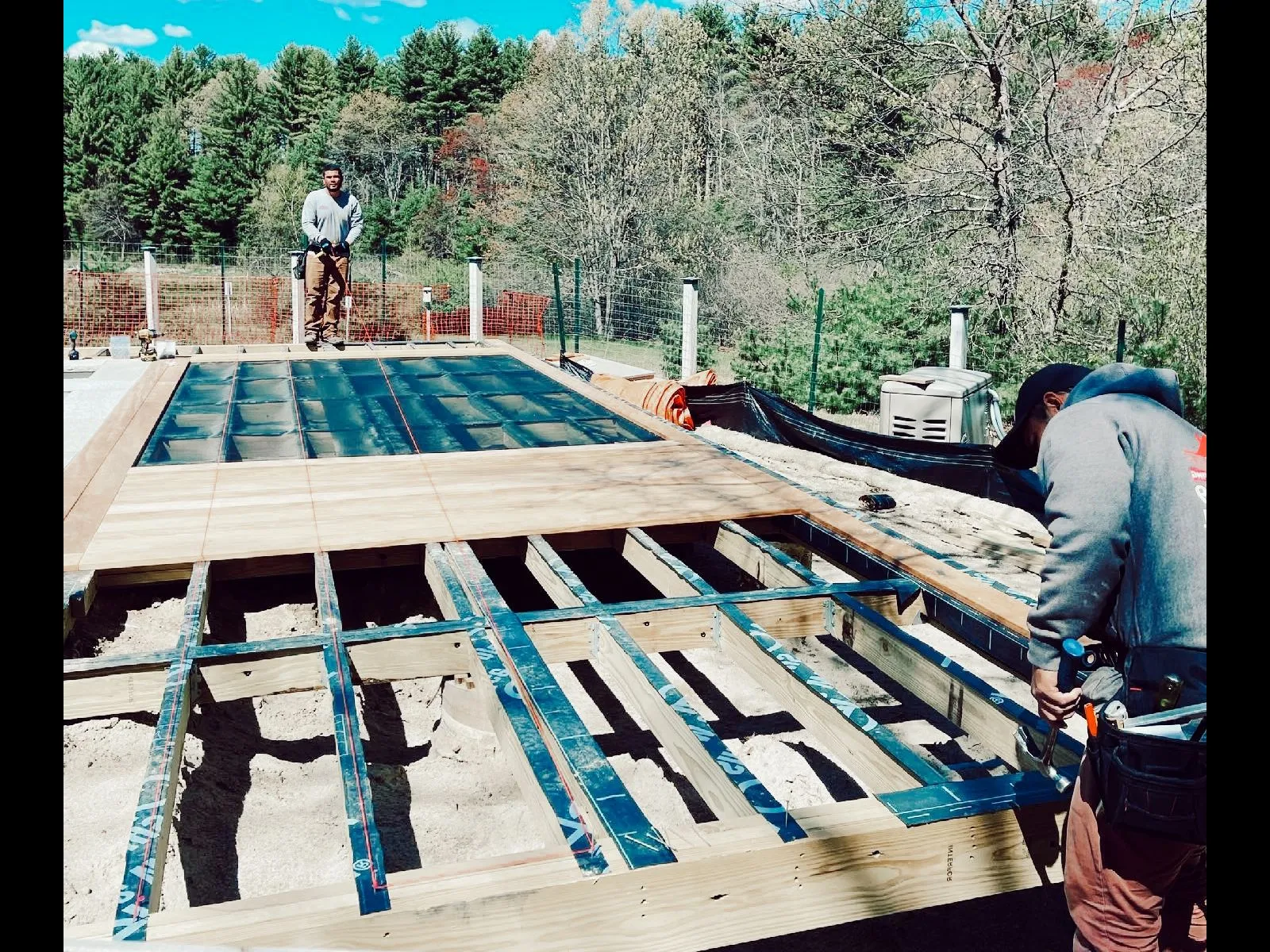 two workers working on a piece of a house